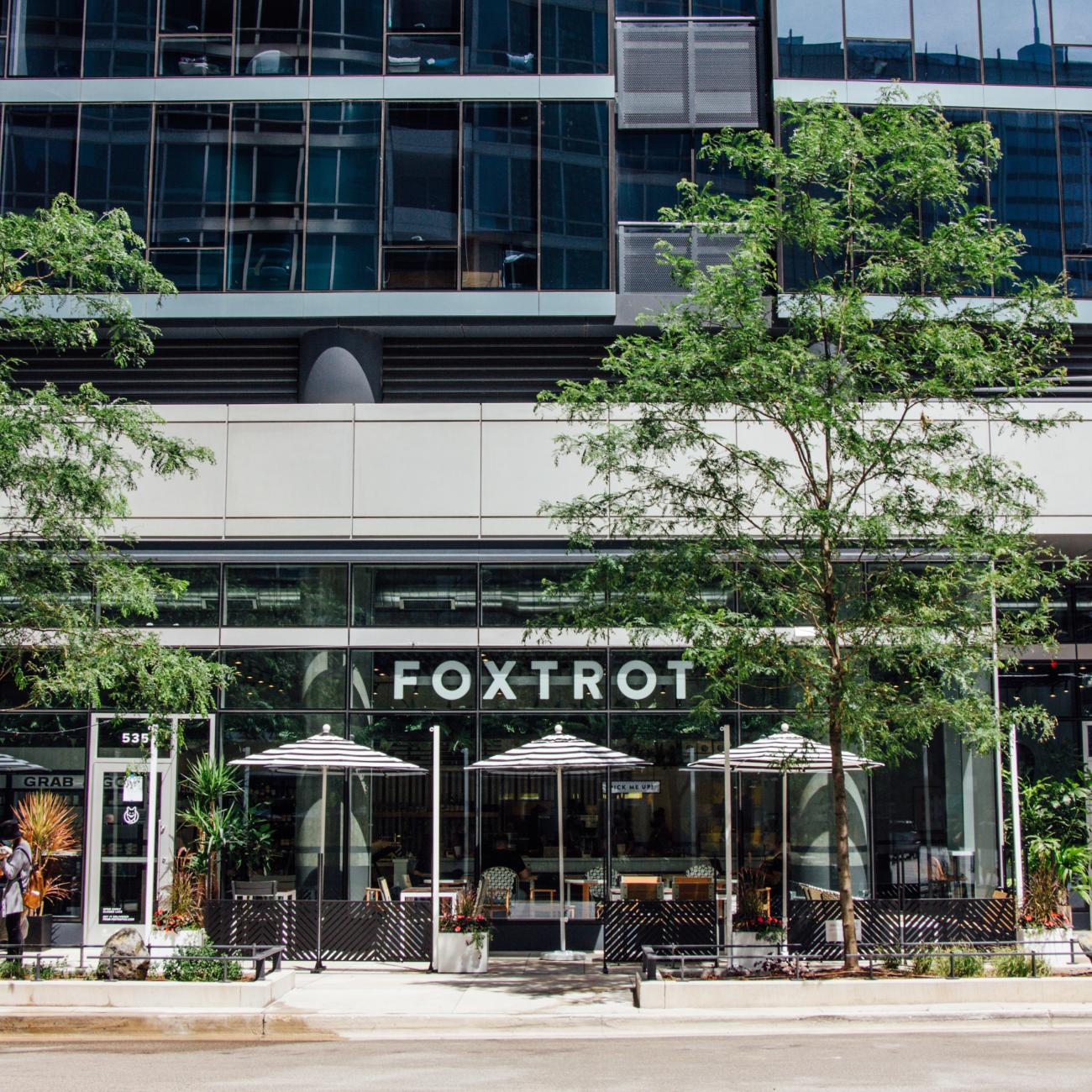 A photo of a Foxtrot store with tress in front.