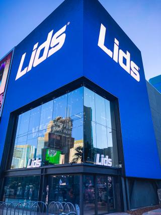 a sign for "lids" atop of its blue storefront