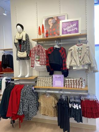 clothing items for children on display inside an evsie store