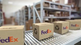 FedEx boxes on a conveyor belt.