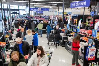 Customers checkout at a Meijer Grocery store.