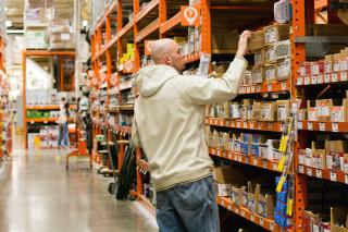 A person shops inside a Home Depot store.