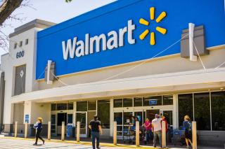 Customers enter and exit a Walmart store.