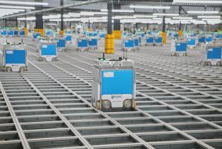 A Kroger delivery robot in a fulfillment facility.