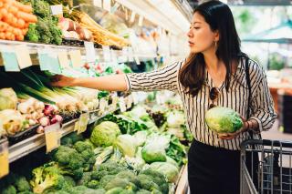 A woman shops for produce.
