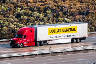 A Dollar General truck on the highway.
