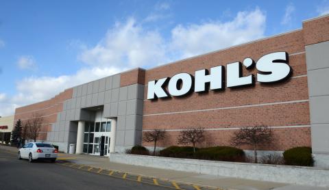 a large brick building with a sign on the side of a road
