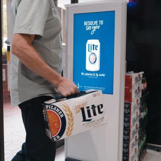 a man standing in front of a refrigerator