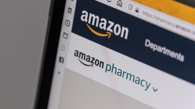 A laptop screen showing the Amazon Pharmacy logo.