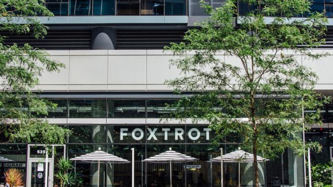 A photo of a Foxtrot store with tress in front.