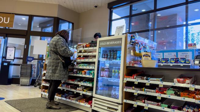A shopper checks out at a Rite Aid store.